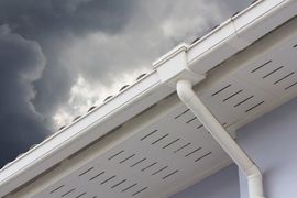 White plastic rain gutter and dark sky. concept : preparing maintenance rain gutter before rainy season.