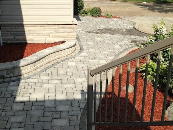 A brick walkway with stairs leading up to a house