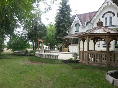 A white house with a gazebo in front of it