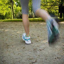 Woman running outdoors in park - motion blur