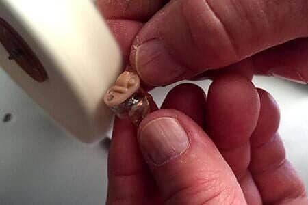 Hearing Aid Repair — Buffing Hearing Aid With Polishing Wheel — Bend, OR Hearing Aid Repair — Buffing Hearing Aid With Polishing Wheel — Bend, OR