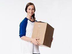 Woman with Cardboard Box — Self Storage in Reno, NV Woman with Cardboard Box — Self Storage in Reno, NV