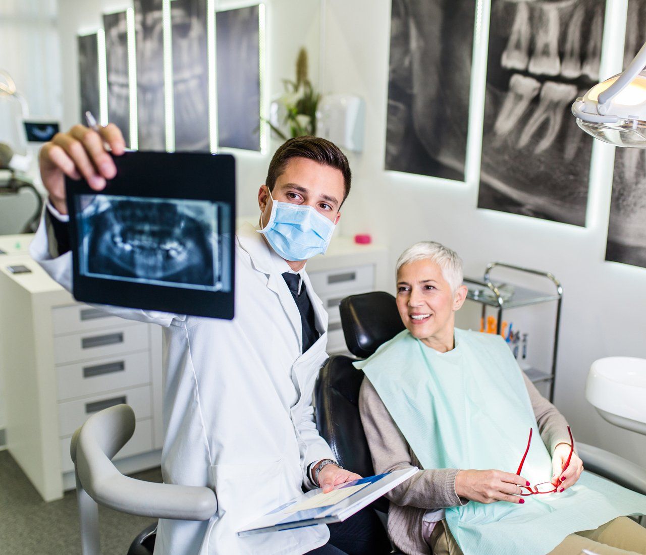 Dentist Checking The Dental X-ray Of His Patient — West Des Moines, IA — Westbrooke Family Dentistry Dentist Checking The Dental X-ray Of His Patient — West Des Moines, IA — Westbrooke Family Dentistry
