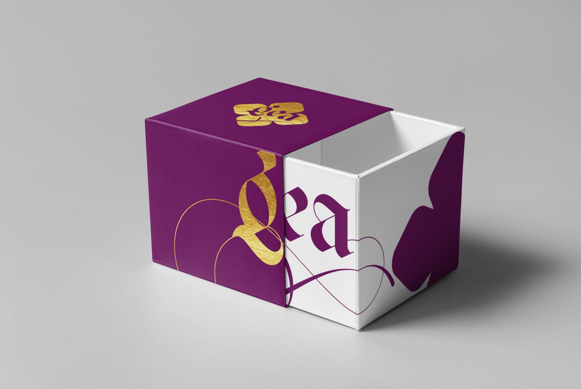 Purple and white sliding box with gold logo and floral design.