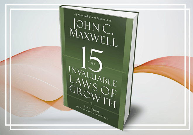 A book titled 15 invaluable laws of growth by john c. maxwell