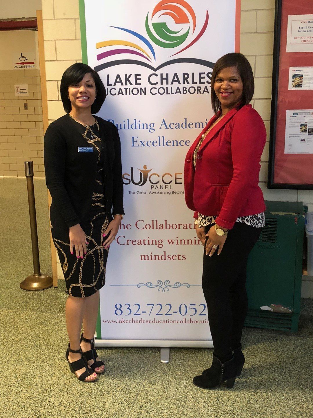 Two women are standing in front of a sign that says lake charles education collaboratora