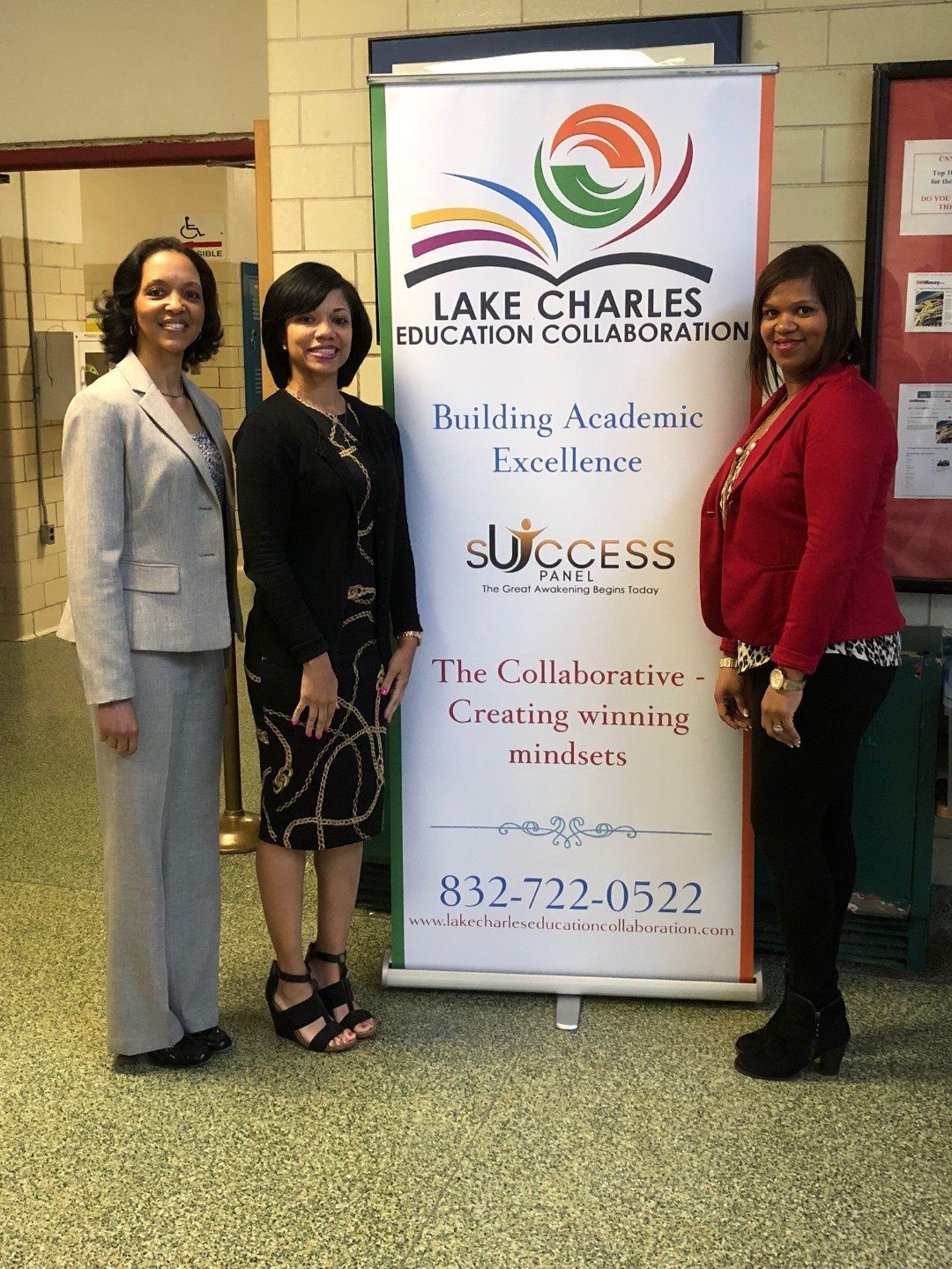 Three women are standing in front of a sign that says lake charles education collaboration