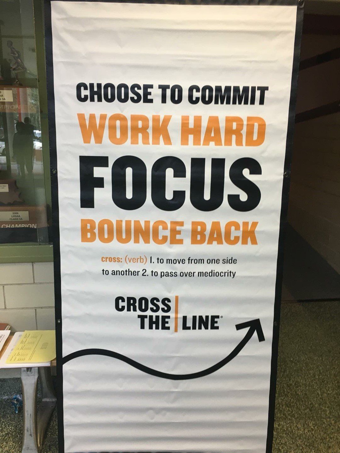 A sign that says choose to commit work hard focus bounce back cross the line
