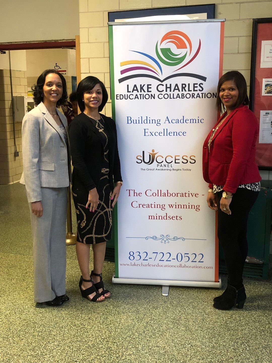 Three women are standing in front of a sign that says lake charles education collaboration