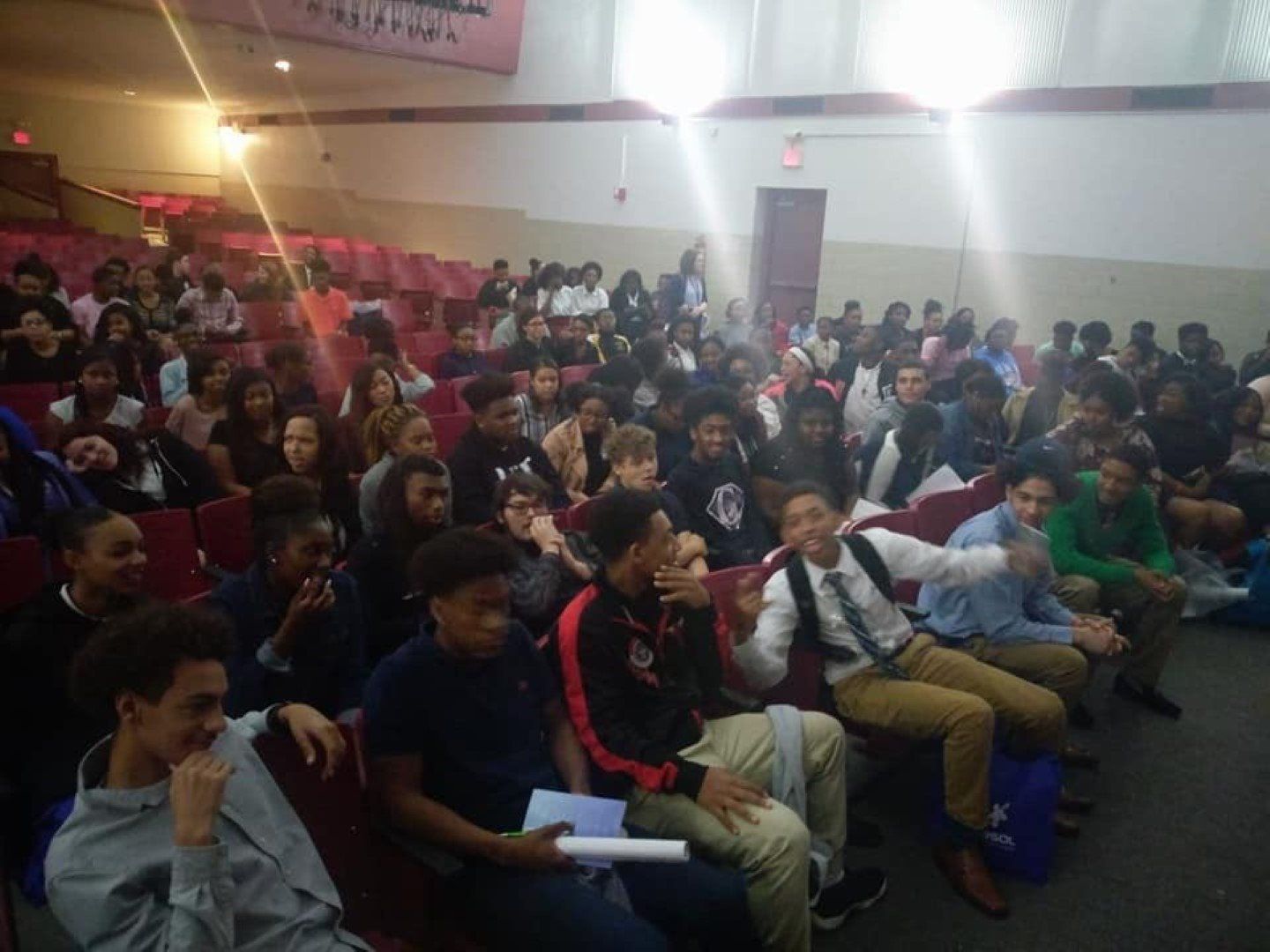 A large group of people are sitting in a theater.