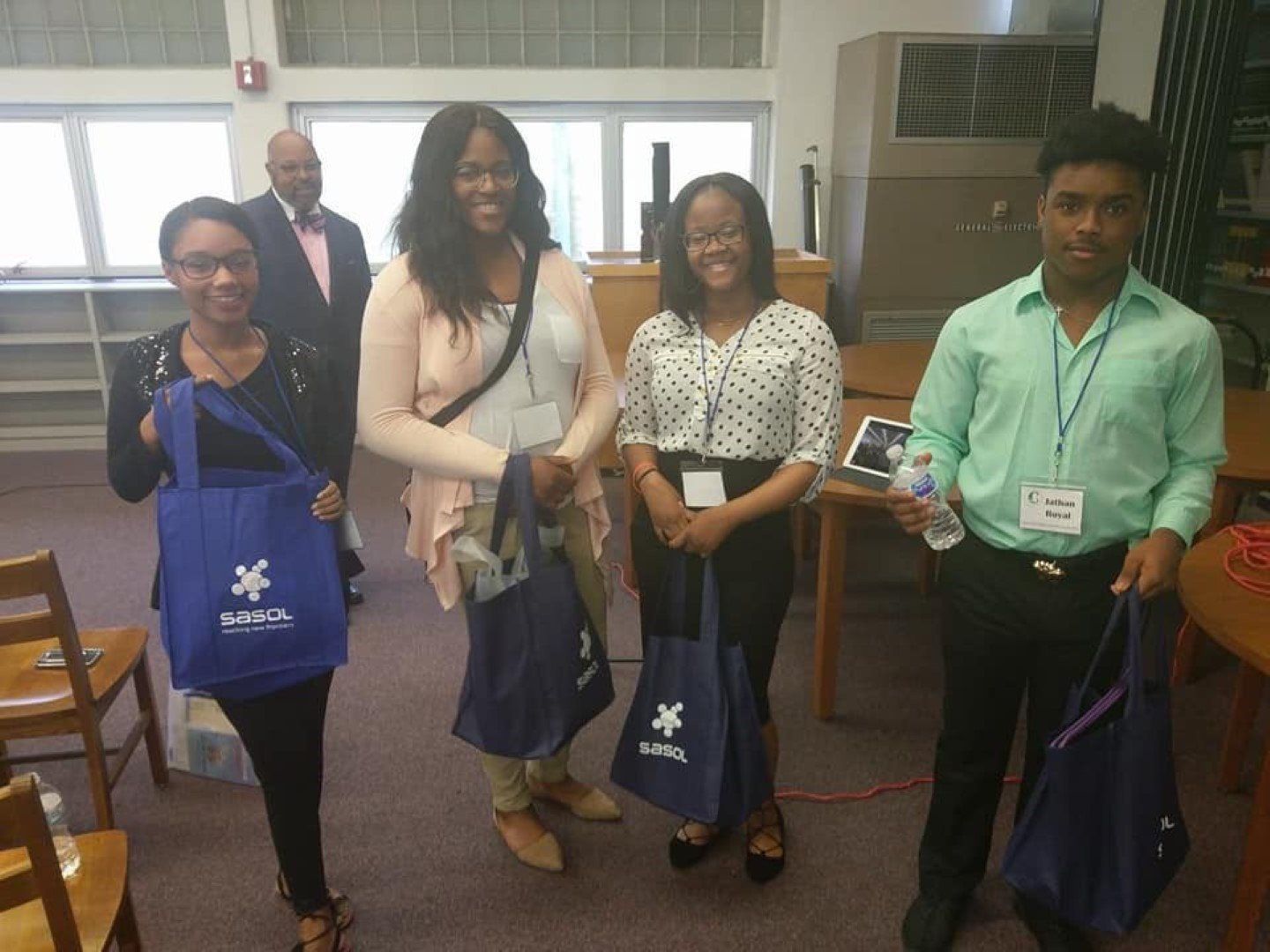 A group of people standing next to each other holding bags that say global