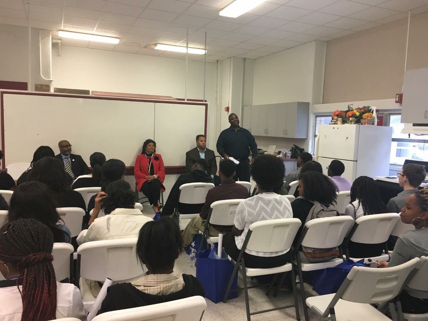 A group of people are sitting in chairs in a room.