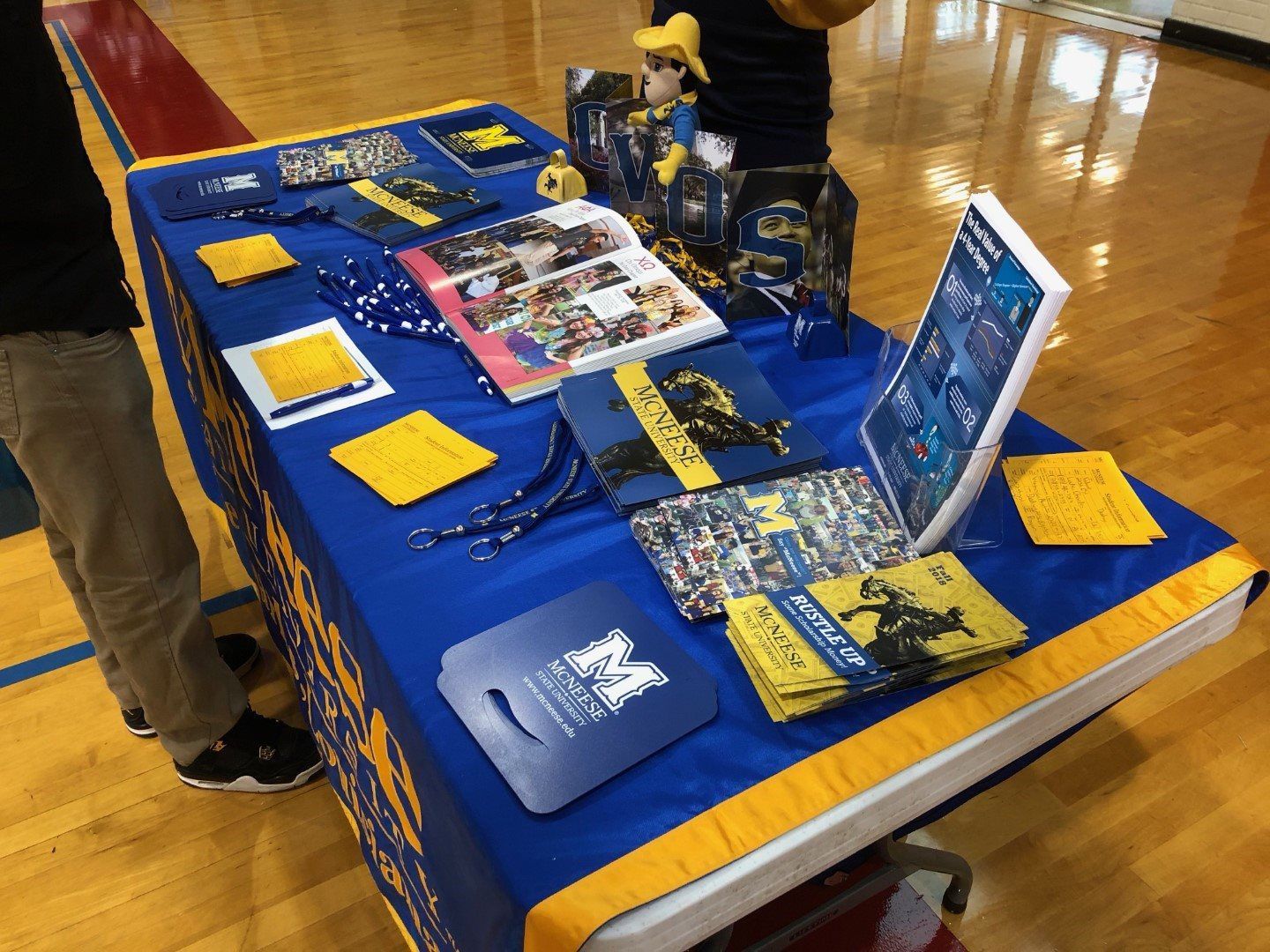 A table with a blue and yellow table cloth and a book on it