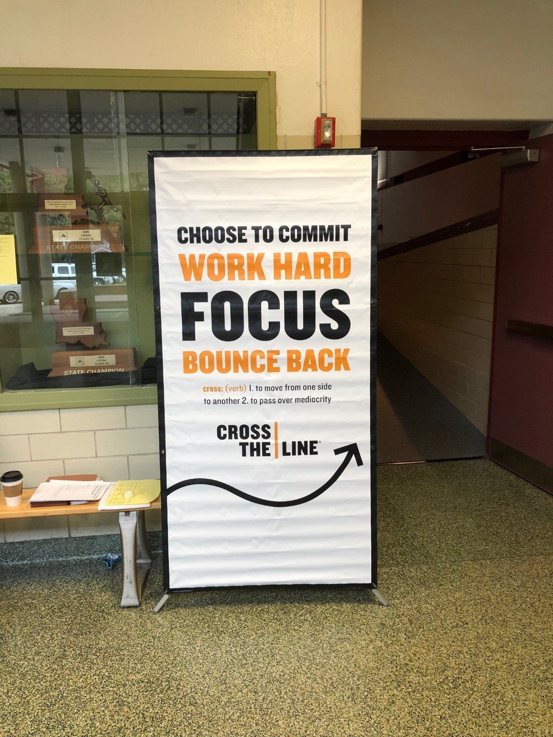 A sign in a hallway that says `` choose to commit work hard focus bounce back ''