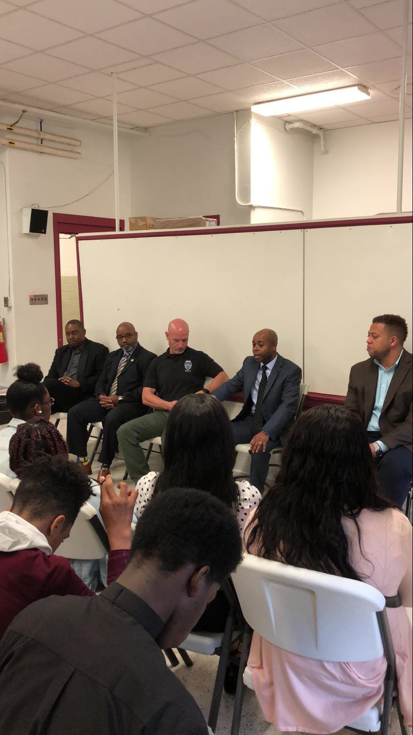 A group of people are sitting in chairs in a room.