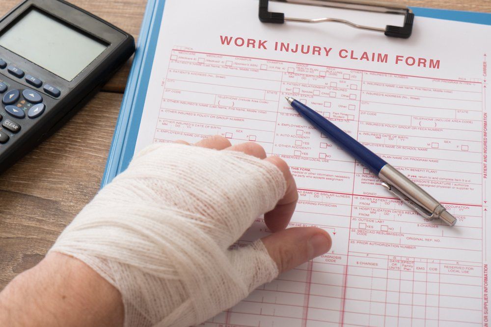bandaged hand near worers comp document