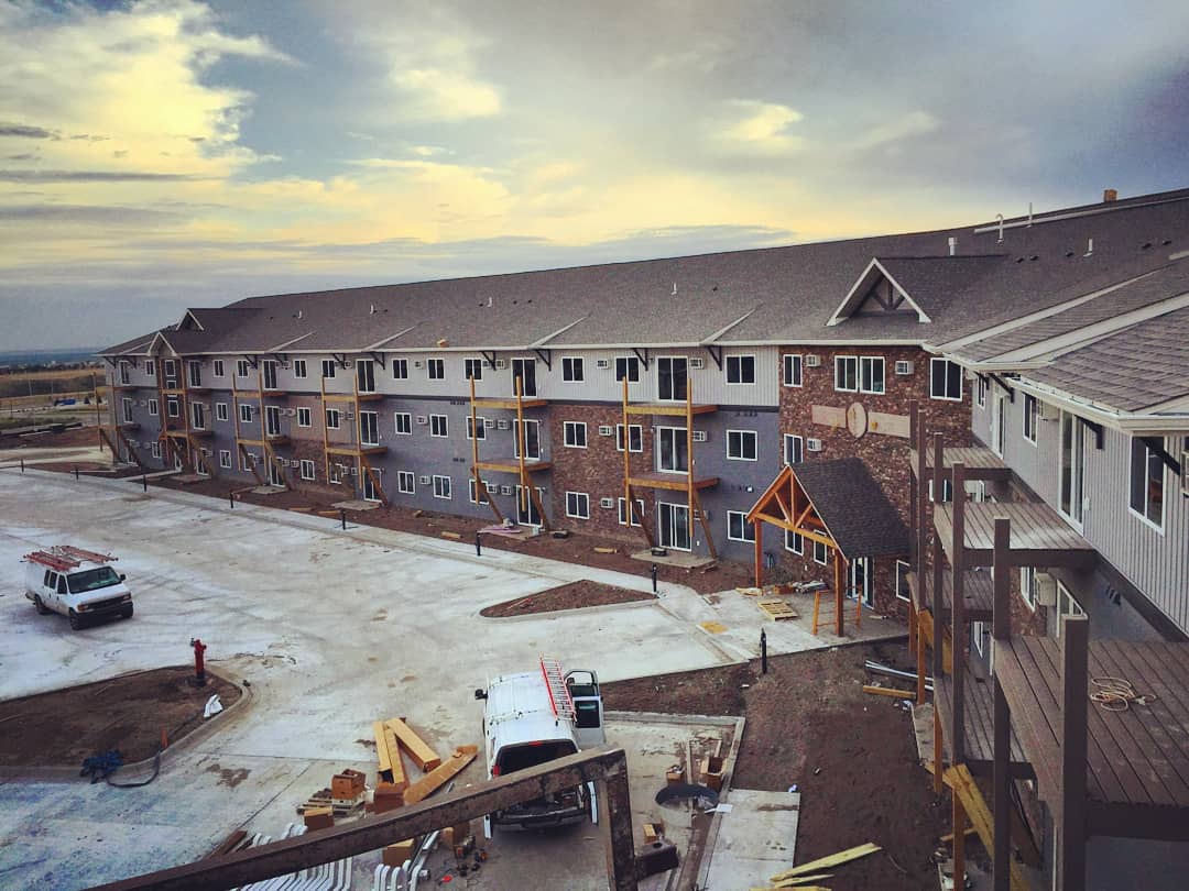 an aerial view of a large apartment building under construction .