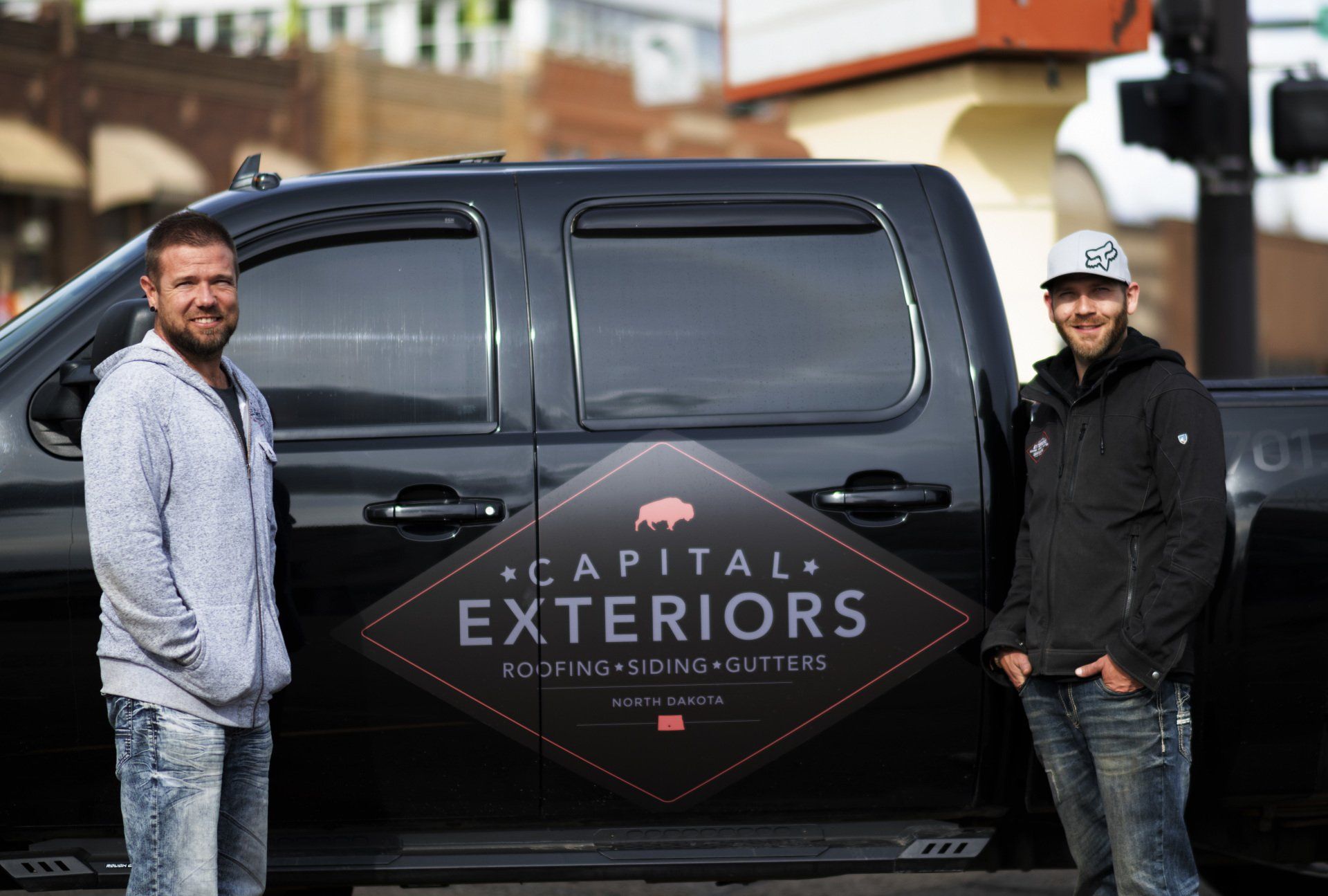 employees atanding by pick-up truck