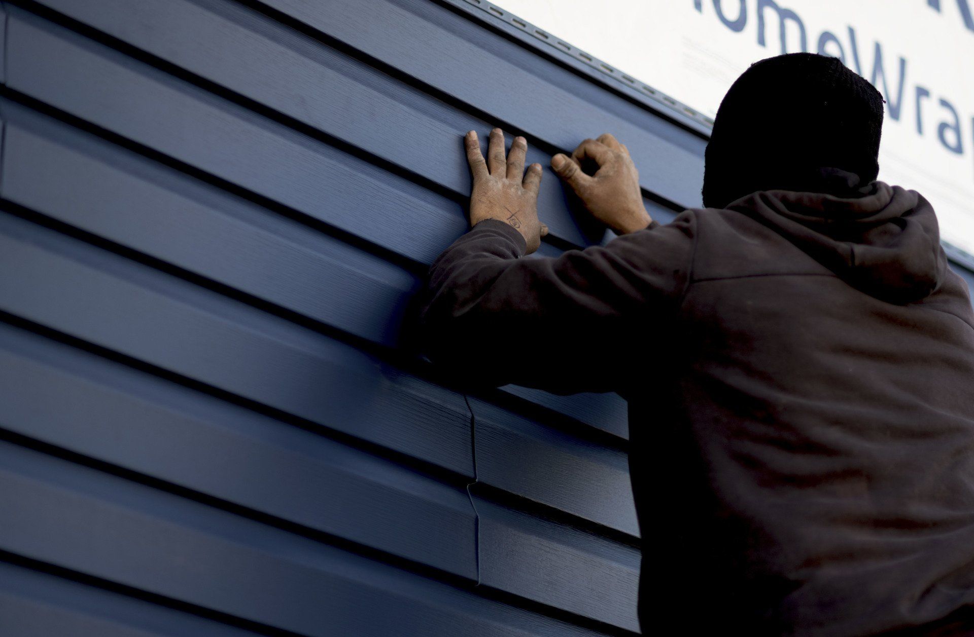 person working on siding