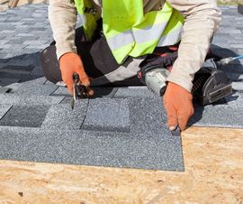 A roofer performing roof repairs