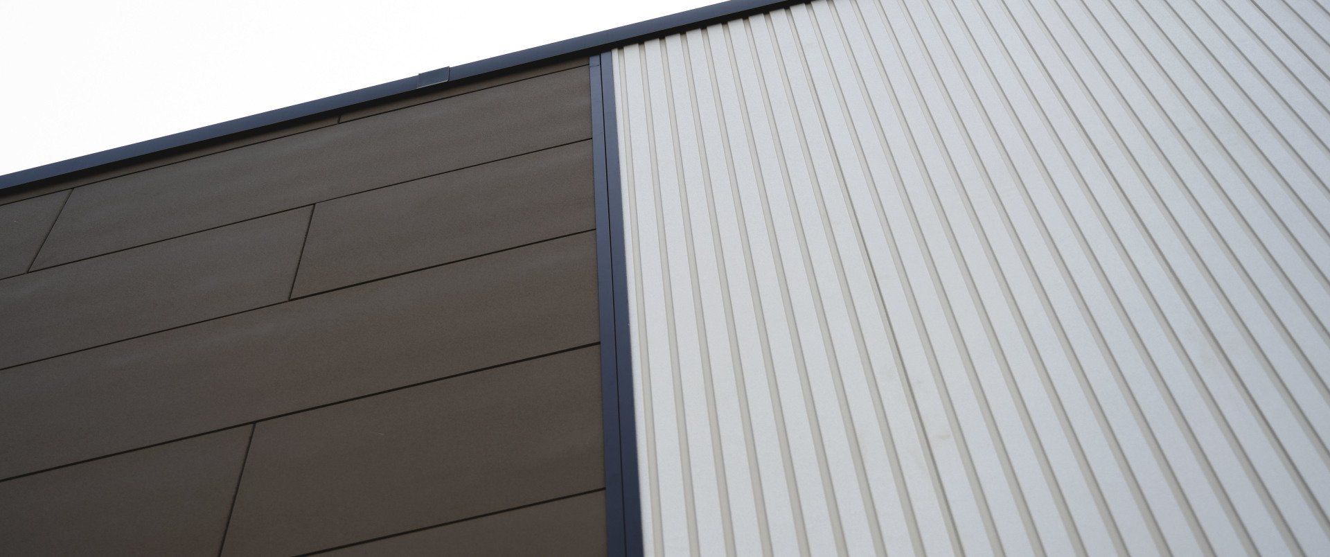 a close up of the side of a building with a roof .