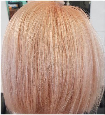 A close up of a woman's blonde short hair