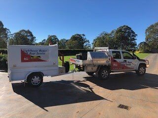 Work Vehicle Pulling Trailer — Lawn Mower and Marine Servicing in Macquarie, NSW