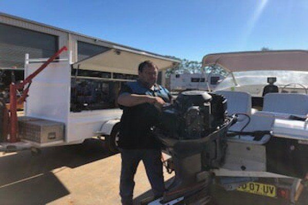 Man Servicing Boat Motor