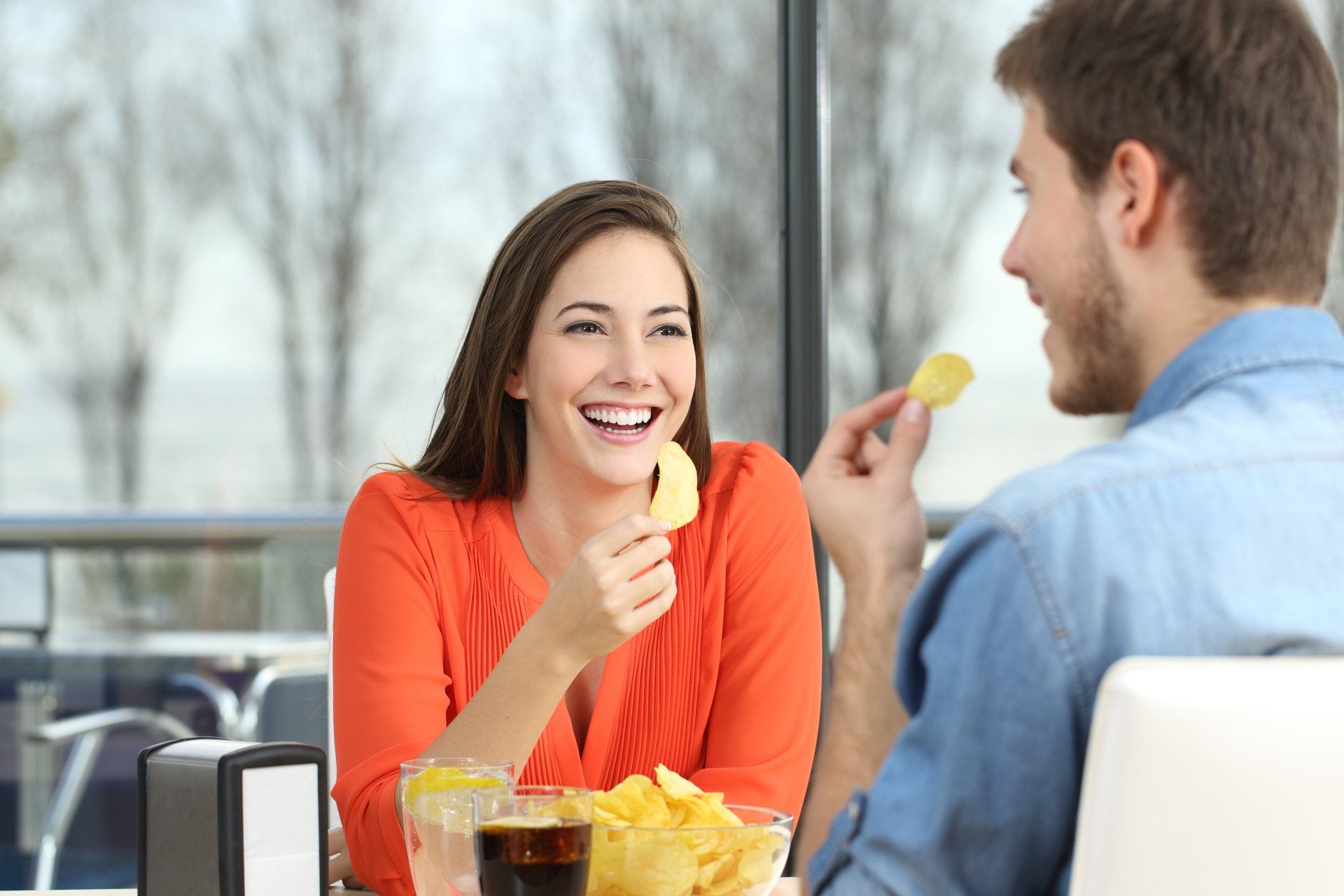 Coffee Machines — Couple Talking And Eating Chip Potatoes in San Antonio, TX Coffee Machines — Couple Talking And Eating Chip Potatoes in San Antonio, TX