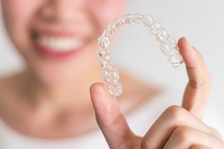 A Woman Holding an Invisalign — Boston, MA — Boston Orthodontics