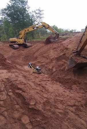 Excavation Contractor — Three Excavator at Work in Marquette, MI Excavation Contractor — Three Excavator at Work in Marquette, MI