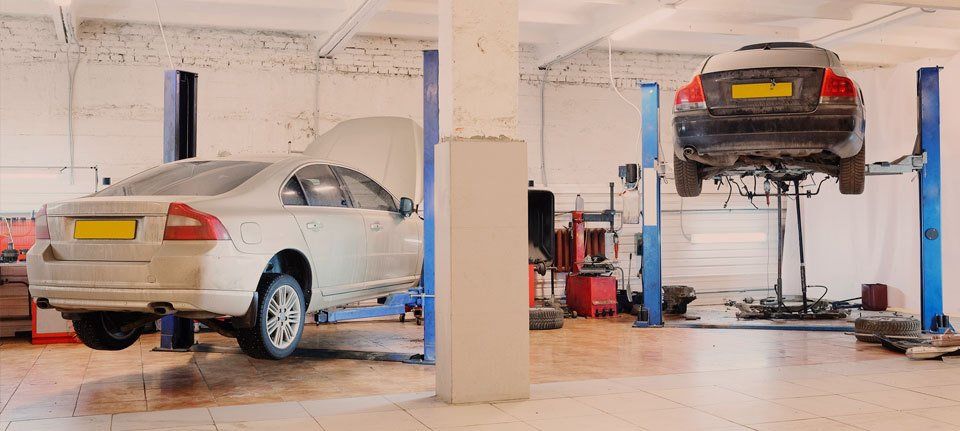 Cars in a workshop, being worked on