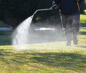 Man Spraying Fertilizer — Landscaping Services in West Lawn, PA Man Spraying Fertilizer — Landscaping Services in West Lawn, PA