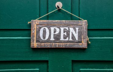 Open sign hangs on door
