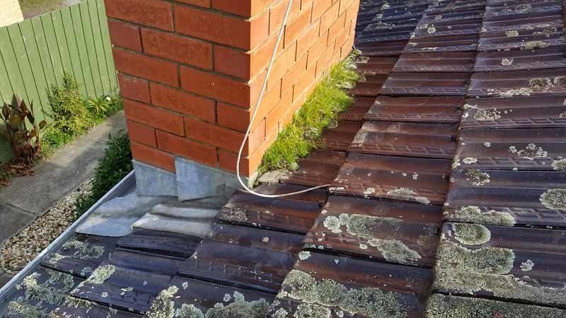 damaged roof with chimney