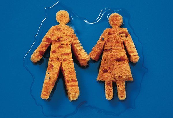 Two breaded human-shaped figures holding hands on a blue background