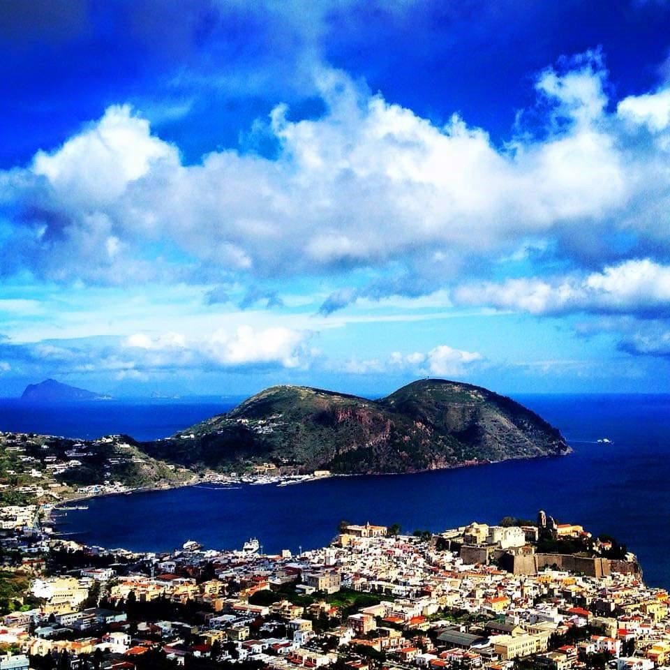 Una vista aerea di una città circondata da acqua e montagne