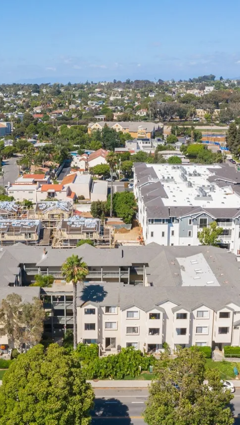 An aerial view of a residential area with lots of buildings and trees.