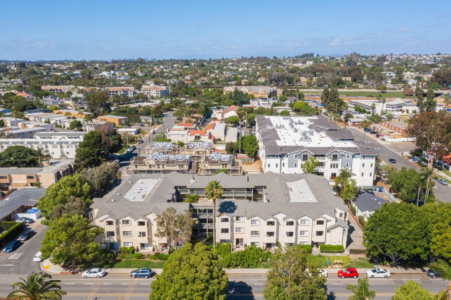 An aerial view of a residential area with lots of buildings and trees.