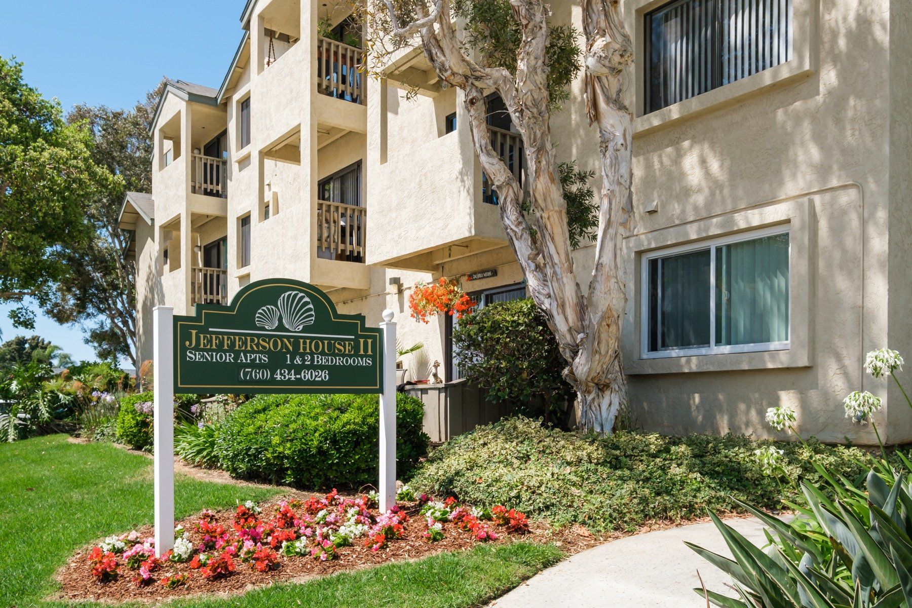 A large apartment building with a sign in front of it.