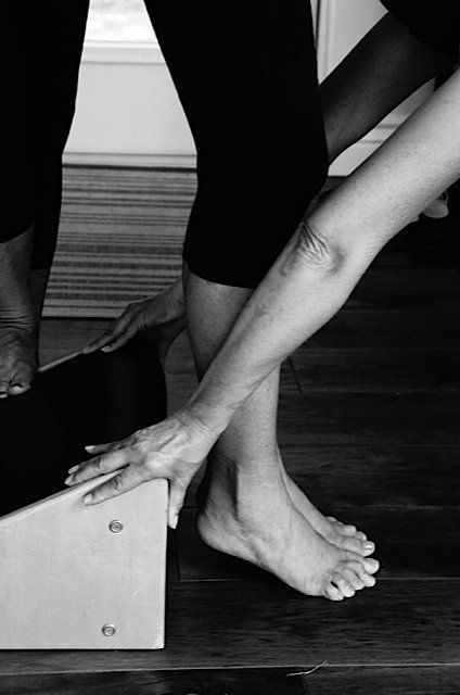 A black and white photo of a person 's legs and feet.