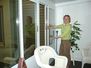 Woman Opening The Window — Roofing And Siding in Toledo, OH
