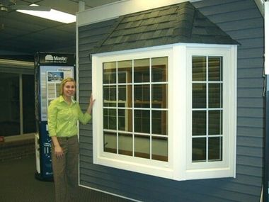 Woman Holding The Window — Roofing And Siding in Toledo, OH