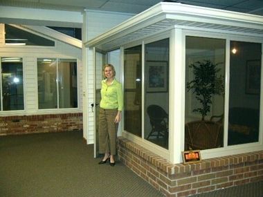 Woman Standing In Front of The House — Roofing And Siding in Toledo, OH
