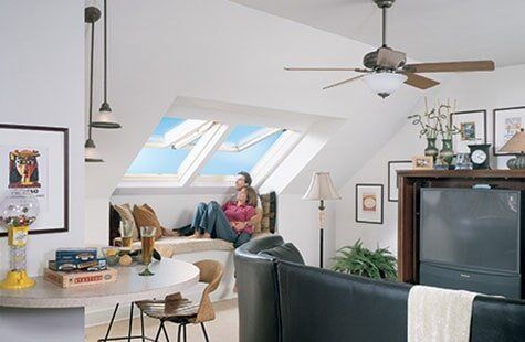 Couple Looking In The Skylight — Roofing And Siding in Toledo, OH