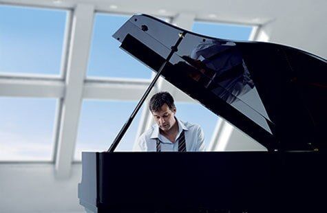 Man Playing A Piano — Roofing And Siding in Toledo, OH