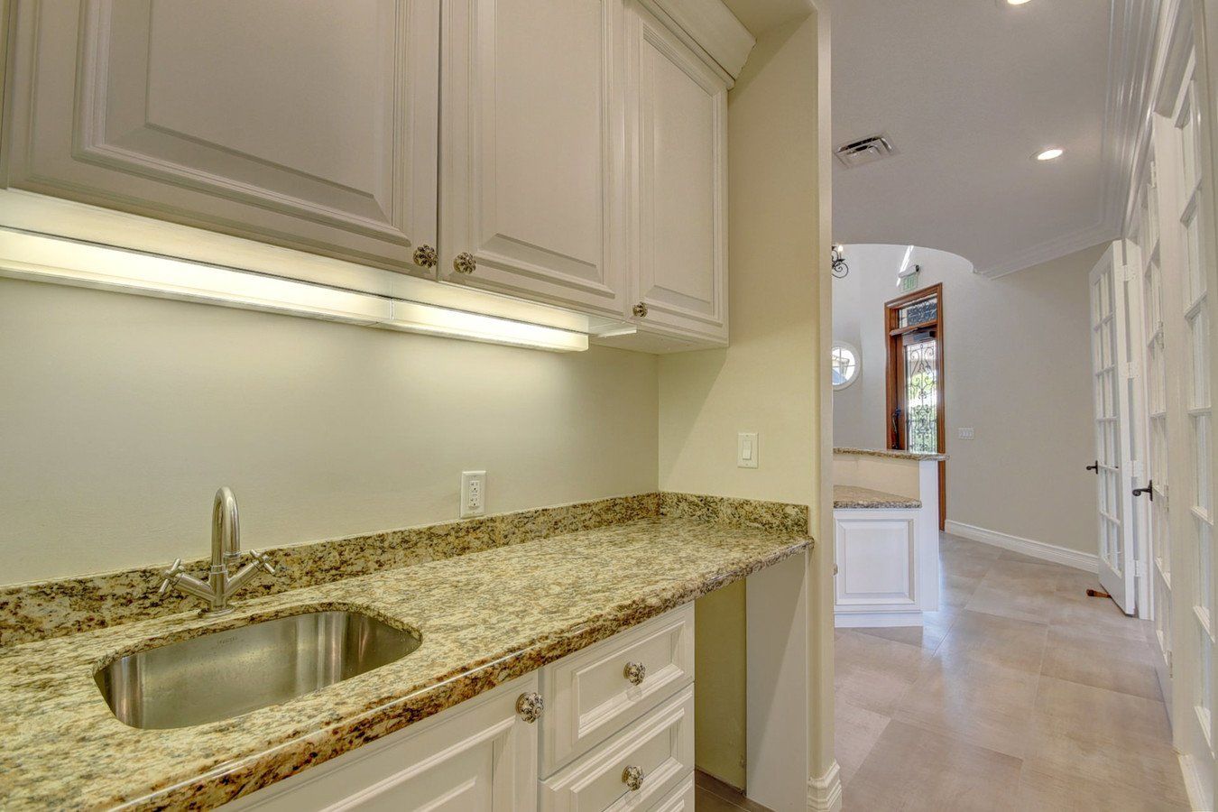A kitchen with granite counter tops and a sink.