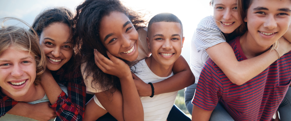 A group of young people are posing for a picture together.