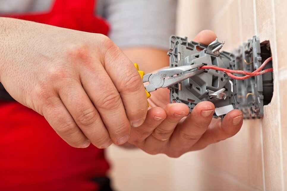 Electrician Fixing Wires — Electrical Services in Jensen, QLD