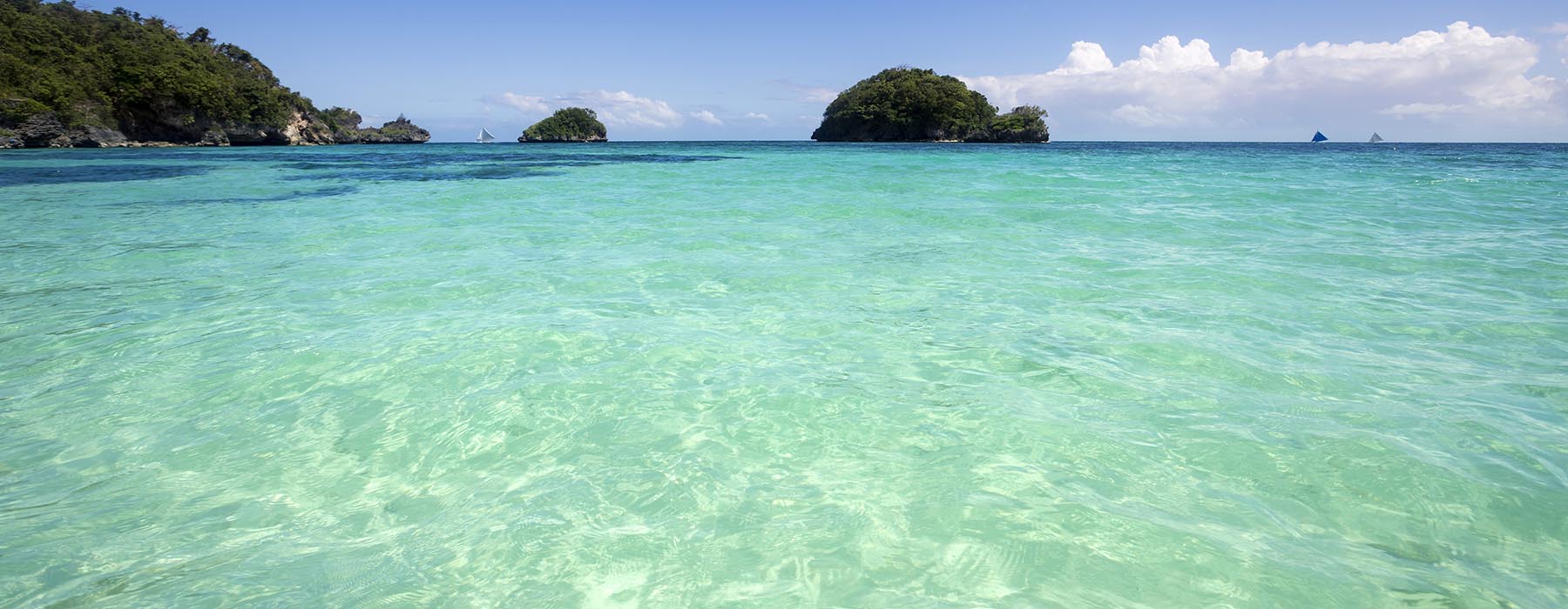 A large body of water with a few islands in the background.